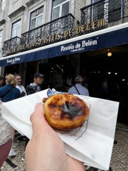 Savoring delicious Pastéis de Nata in front of the iconic Pastéis de Belém